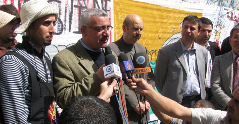 Photo of Palestinian Youth Call for National Reconciliation through Wall Painting Activity